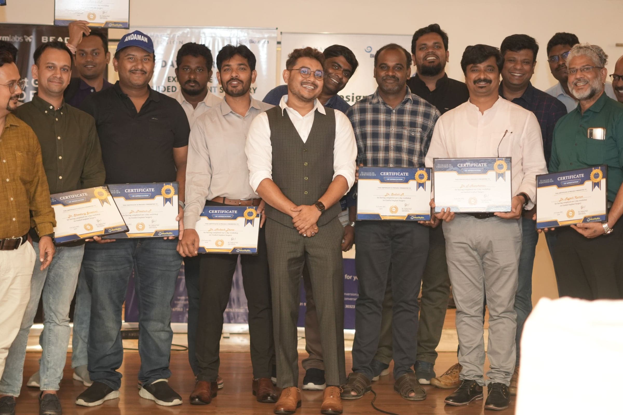 A SurgiGuideExcellence cohort with their completion certificates