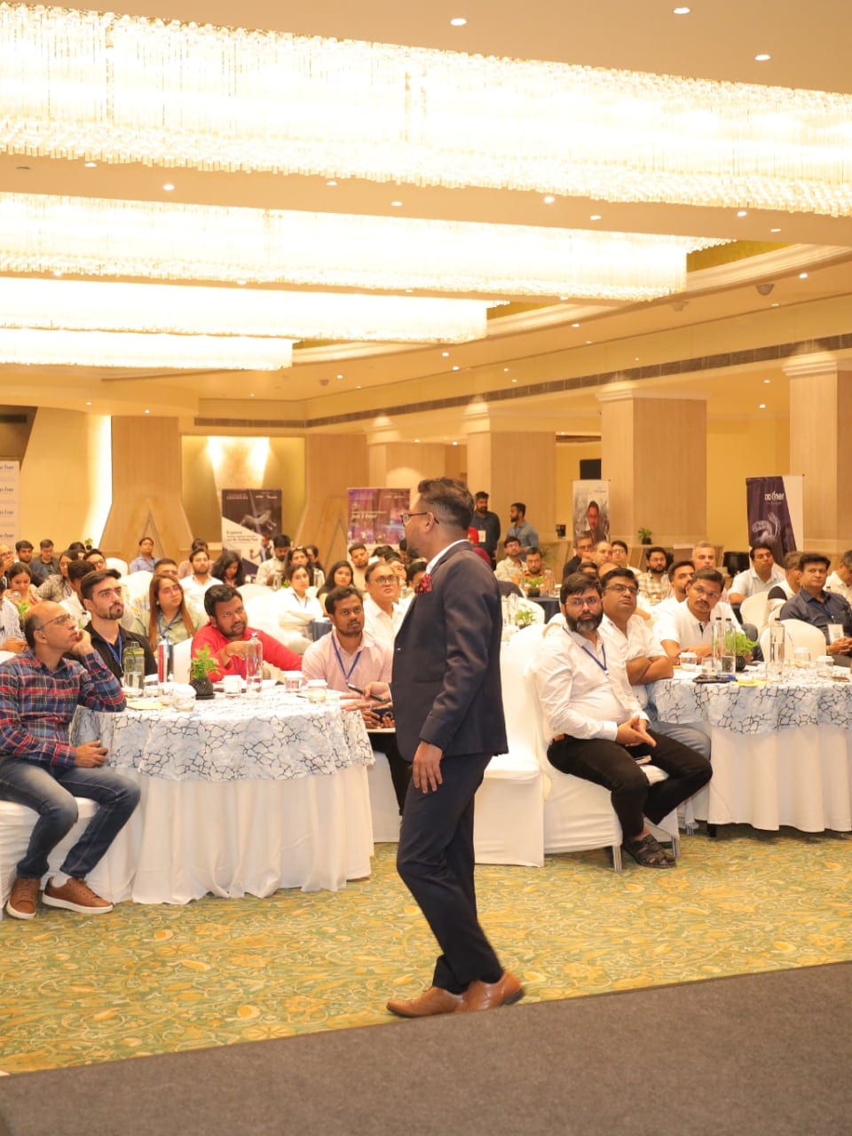 Sudeep Paul presenting to a full hall of clinicians